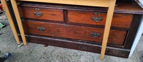 An oak chest of drawers and a low chest of two short and one long drawer
