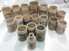 A collection of stoneware jars with later transfer advertising labels.