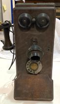 An early 20th century Western Electric made in the USA, oak cased wall telephone with bakelite