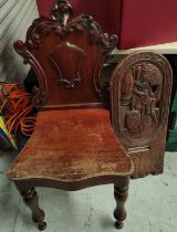 A carved African Tribal seat back; a mahogany shield back hall chair