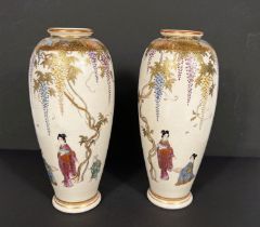 A pair of Japanese Meiji period finely decorated satsuma vases with gilt highlights and vines and