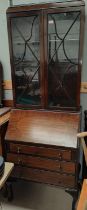 A 1920's mahogany bookcase with 2 glazed doors over fall front, 3 drawers and cabriole legs