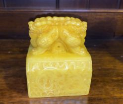 A large Chinese Republic period Imperial yellow heavily carved soapstone seal depicting mythical