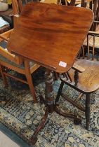 A 19th century mahogany tilt top occasional/ reading table with turned column on three legs, with