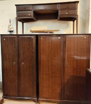 A Stag Minstrel three piece bedroom suite with dressing table with triple mirror and five drawers