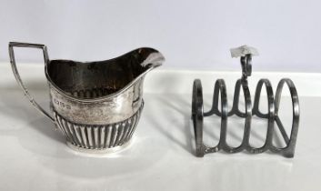 A 4 division toast rack, Birmingham 1929;  a hallmarked silver cream jug in the Georgian style,