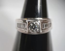 A gentleman's white metal dress ring set with central circular diamond, approx. 0.7 carats with 5