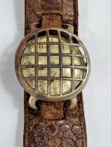 An early 20th century silver gents officer style trench watch with original nickel stone guard on