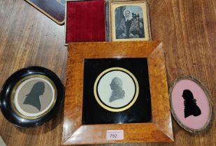 Three framed Georgian style silhouettes of Georgian gentlemen in various frames and a tin type