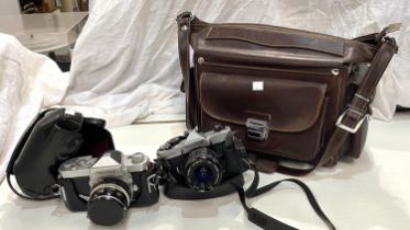 A Nikkormat FTN SLR camera; a Fujica STX1 SLR camera in leather carrying case