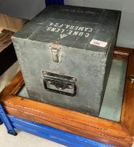A military Storage case Cune lens in grey, and a hinged table top display cabinet.