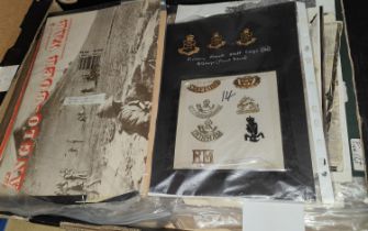 A selection of cap badges and a selection of military pictures and ephemera.