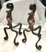 A pair of Arts and Crafts firedogs in the Liberties, Archbold Knocks style with copper scroll,