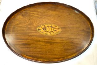 A mahogany oval 2-handled tray with central shell motif