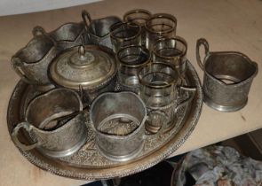 A Persian white metal tea and coffee service six of each cup with larger tray, (tea just sleeves