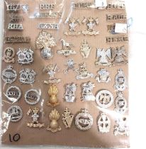 A collection of 42 military collar badges.