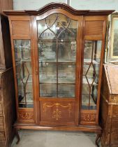 An Edwardian Sheraton dome top, full height mahogany display cabinet with moulded frieze, and glazed