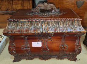 A reproduction carved wood shoe shine box with various compartments