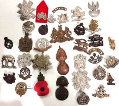 A collection of military cap, shoulder badges etc.