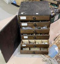 A watchmakers cabinet full of watch parts etc