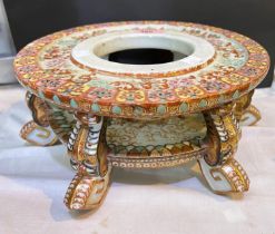 A large 19th century Chinese porcelain vase stand decorated in reds and gilts with polychrome