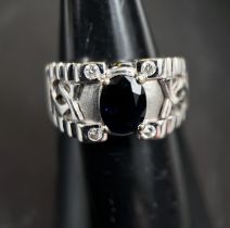 A gentleman's white gold dress ring with central oval blue sapphire and with small diamond to each