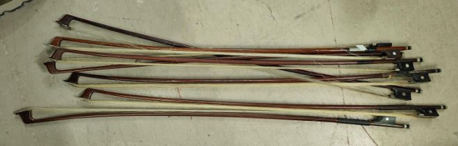 A collection of various violin bows inset with mother of pearl details to ends, frogs etc