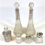 A pair of cut glass slender scent bottles with hallmarked silver collars (1 stopper a.f.); a scent