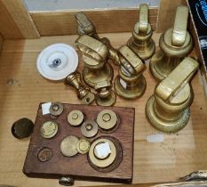 Nine brass graduating bell weights; scientific weights