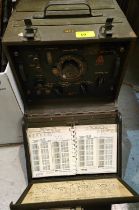 A post WWII military Signal Corps Frequency meter with internal booklets