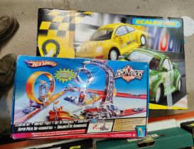 A Hot Wheels set and a Scalextric set.