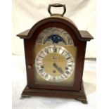 A reproduction Georgian style bracket clock in mahogany arch top case, with silvered and brass dial,