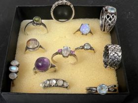 11 gem set white metal dress rings.