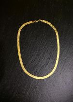A yellow metal necklace of flattened zigzag design, stamped 375, 10gm