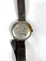 A WWI period officers trench watch with spring protective monogrammed front, on leather strap