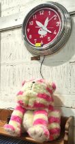 A modern Neon Pink plug in Playboy Bunny Clock and a Vintage Bagpuss plush cat.