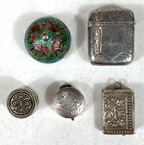 A hallmarked silver vesta case, a white metal vesta in the form of a book and three white metal pill