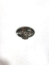 Georg Jensen:  a silver pierced oval brooch with 3 flowers, stamped Georg Jensen Sterling Denmark No