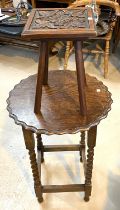 A 1930's oak occasional table with circular scalloped top on barley twist legs; a small carved plant