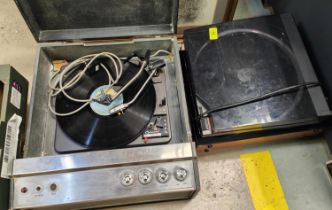 A vintage record turn table and a KB portable record player.