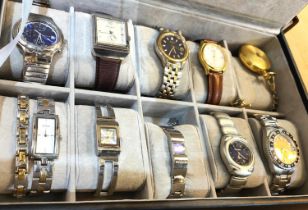 A collection of watches in watch box, various makes and styles.