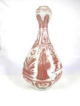 A Chinese porcelain vase of octagonal form with garlic bulb top, decorated in underglaze iron red