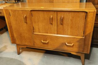 A mid 20th century G-plan light oak sideboard with cupboards and drawers bellow, L122cm