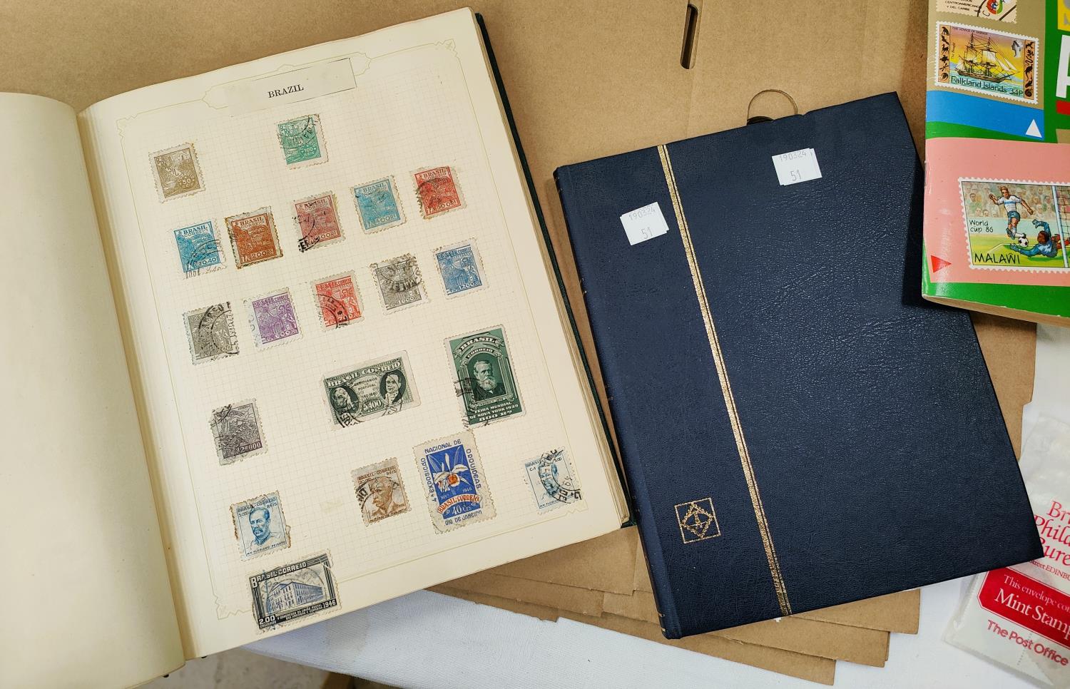 Two albums and a stockbook containing a collection of stamps