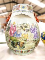 A Chinese ovoid vase of large size with deers head handles, decorated in colour enamels with genre