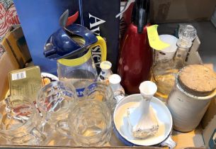 A selection of bar accessories including soda syphons, china and glasses