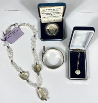 A yellow topaz and quartz necklace; a silver pendant; a silver proof Charles & Diana marriage