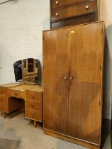 A mid 20th century light oak dressing table and matching double wardrobe