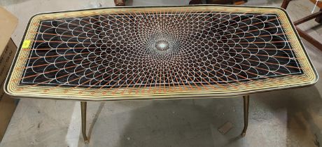 A mid 20th century coffee table, canted rectangular form with geometric design