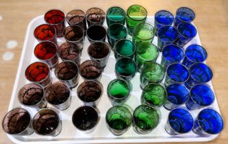 A selection of approx. 45 blue, red and green 'shot' sized glasses with silvered decoration of